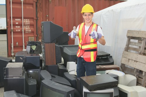 Construction site with builders clearing waste in Hammersmith